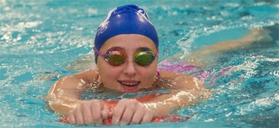 Child with goggles swimming 