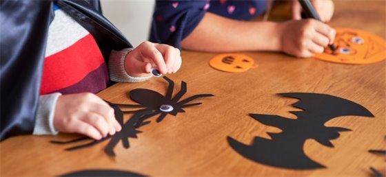 Children making Halloween themed arts and crafts.