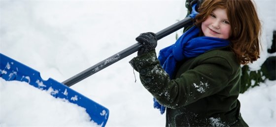 A Snow Angel volunteer shoveling snow.