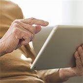 Image of a hand holding an iPad 