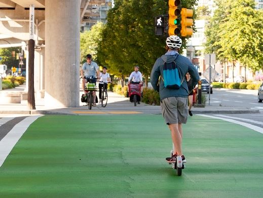 Escooter rider riding through intersection