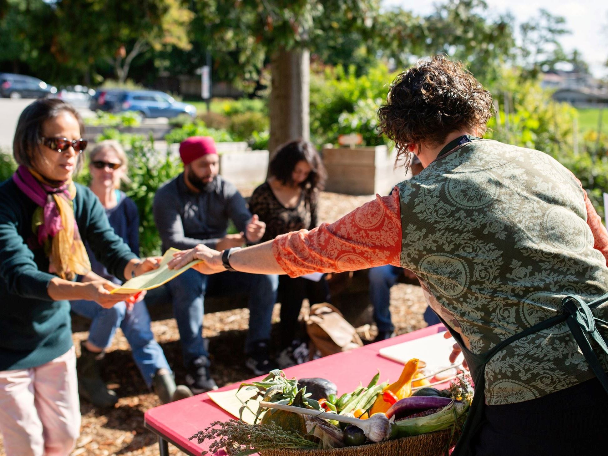 Grant recipients handing out vegetables to community members.