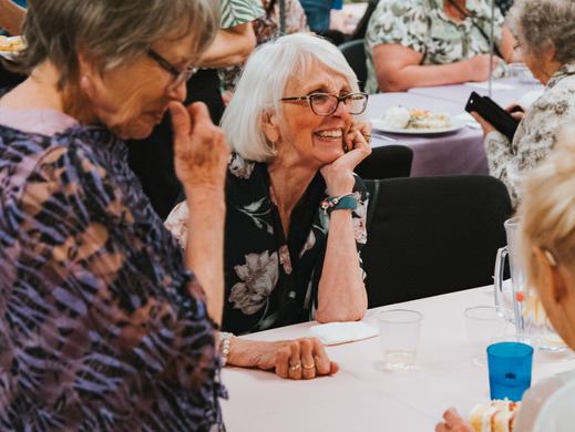 Women gathering and smiling