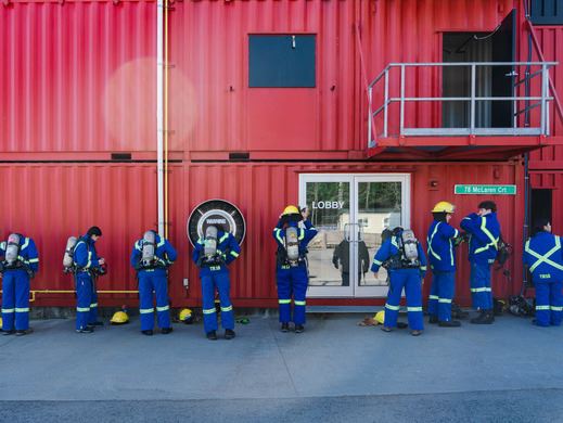 Junior Firefighter students putting on gear outside the fire training centre