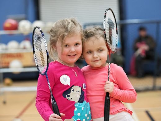 Two children playing badminton