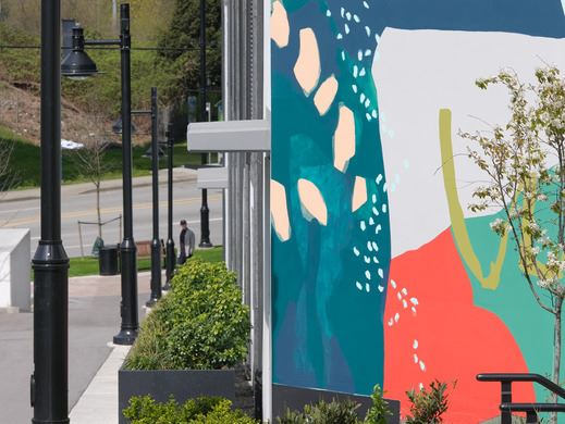 View of a colourful mural painted on the side of a building in southwest Coquitlam