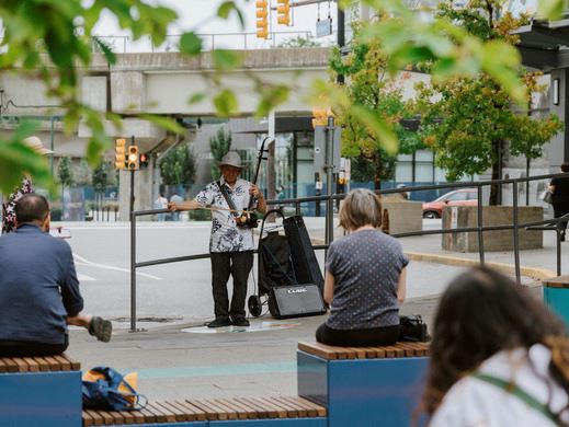 A performer playing while people listen and watch the performance