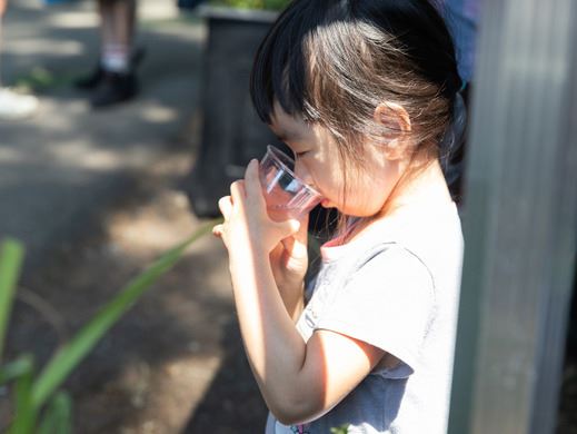 Child drinks a cup of water