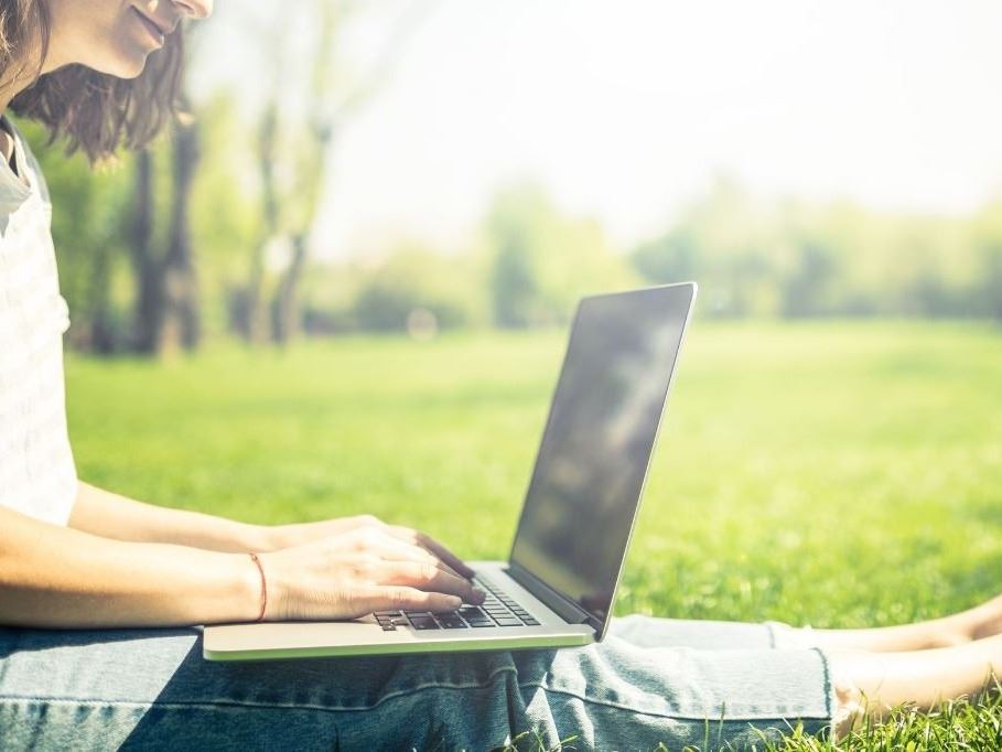 Woman in park on a laptop