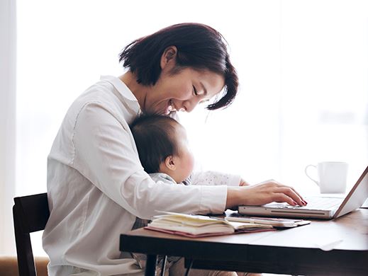 Woman and son working on a laptop computer.