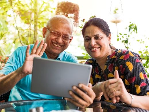 Seniors waving at tablet 