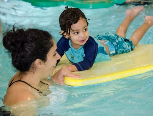 Adult and child swimming
