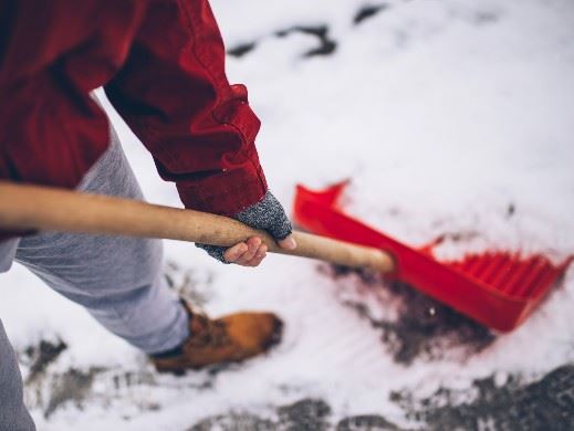 Man shoveling snow from City sidewalk 