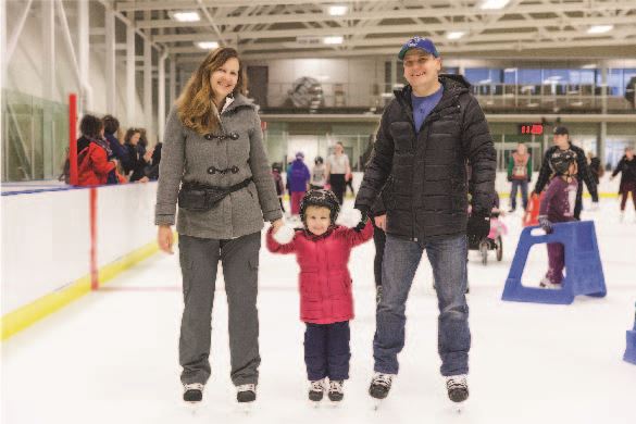 Family of three skating and smiling for the camera