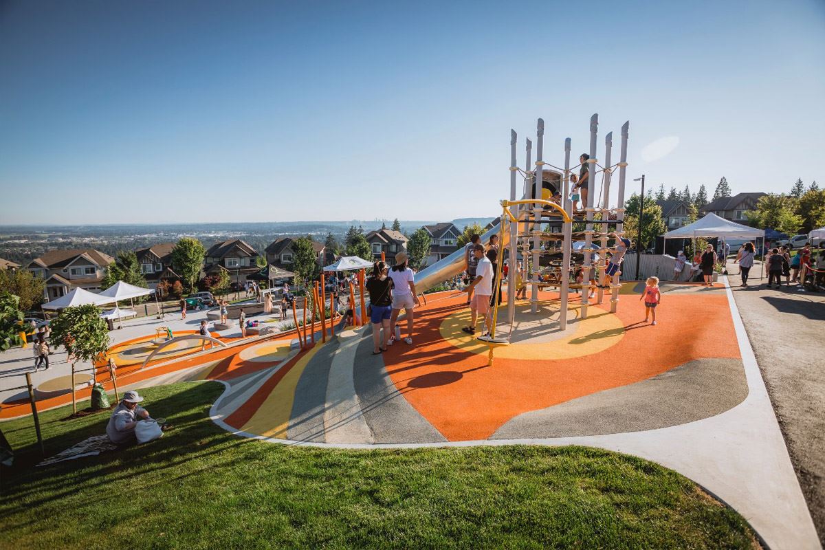 Down hill view of children playing on playground equipment. 