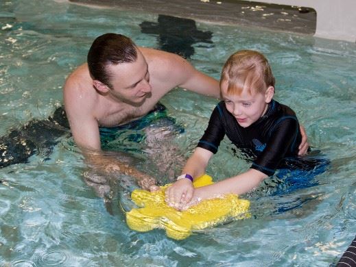 Swim instructor and child