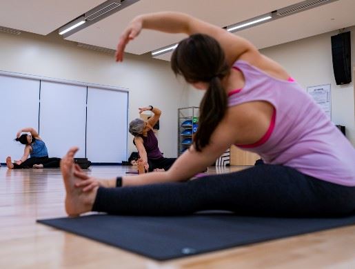 Adults stretching in a yoga class