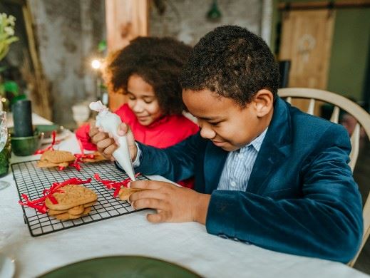 Two kids decorating cookies