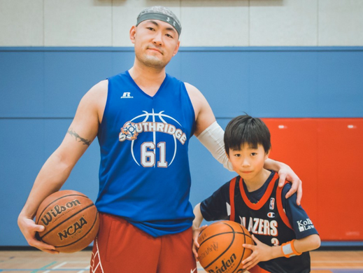 Adult and child playing basketball