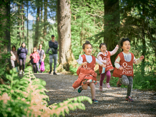 Group of children running in the forest